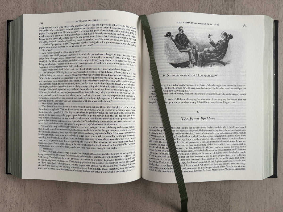 Open book with text and a small illustration on a gray background