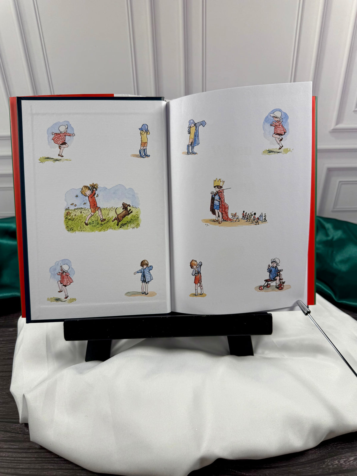 When We Were Very Young hardcover opened to illustrated endpapers featuring colorful E. H. Shepard drawings of children playing and dressing up.