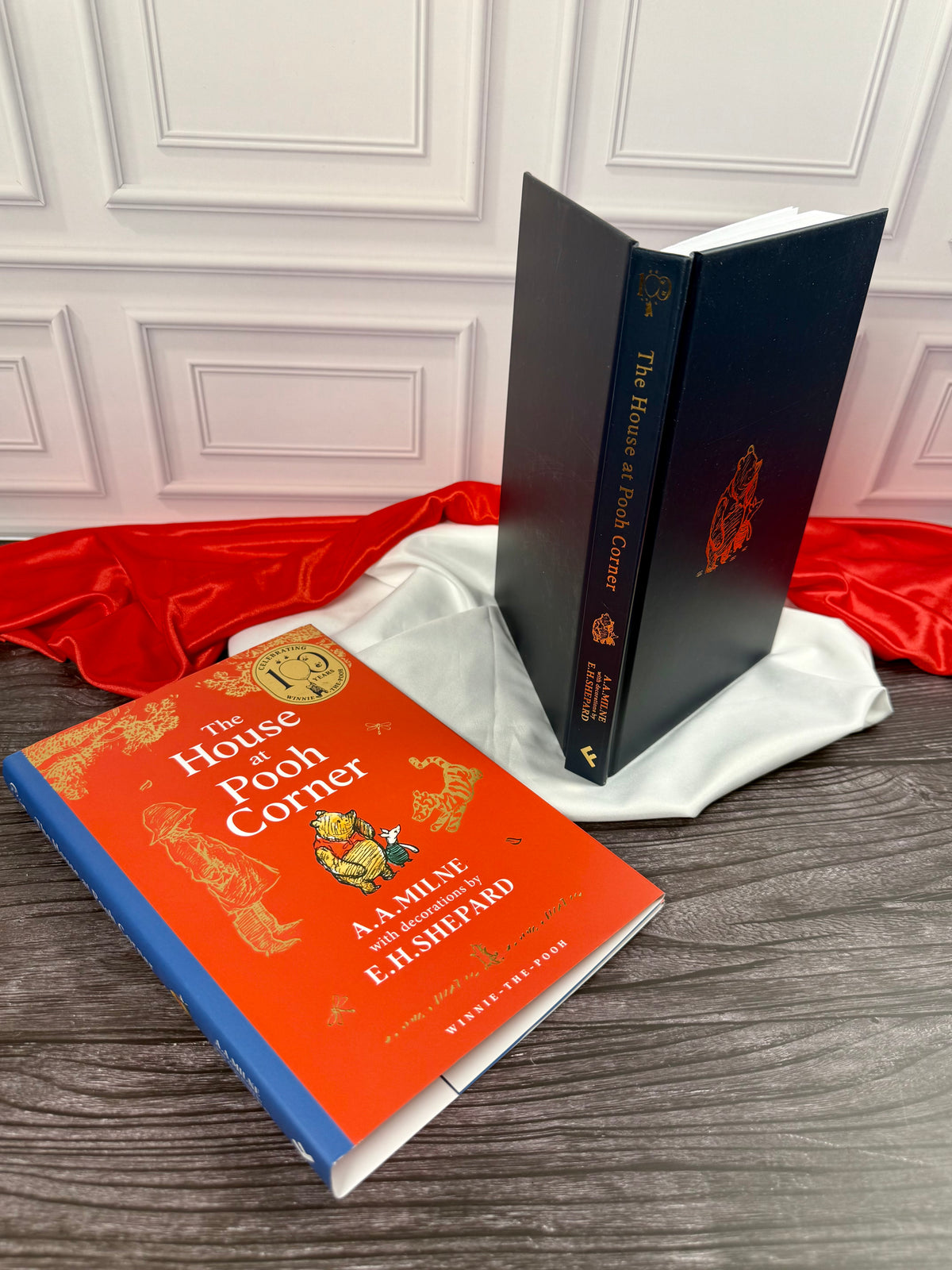 The House at Pooh Corner anniversary edition showing the illustrated dust jacket removed to reveal the dark blue hardcover binding