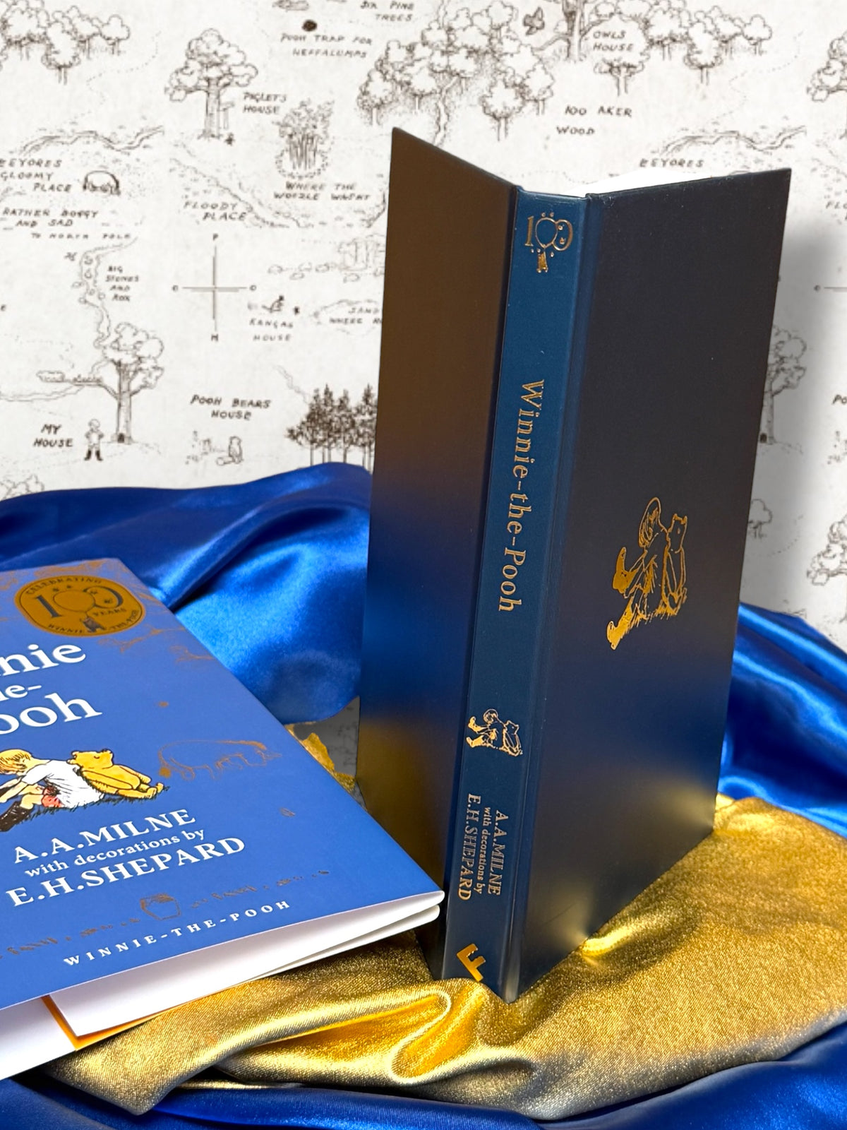 Winnie-the-Pooh hardcover without dust jacket showing dark blue binding, gold spine lettering and gold illustration