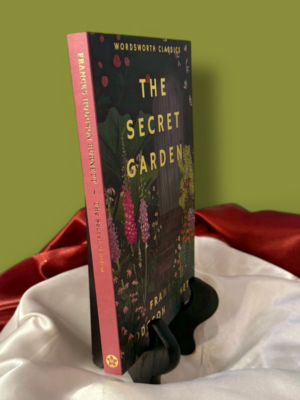 Angled view of The Secret Garden by Frances Hodgson Burnett, showing the Wordsworth Classics paperback cover and spine.