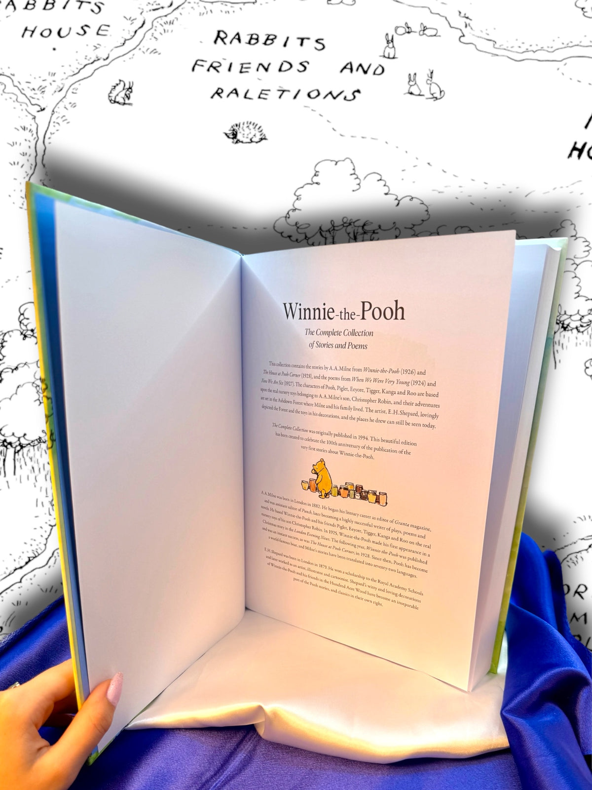 Winnie-the-Pooh complete collection by A. A. Milne opened to reveal its illustrated hardcover binding and interior pages.
