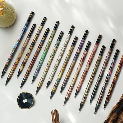 Set of intricately designed pens on a white surface with a small decorative item.