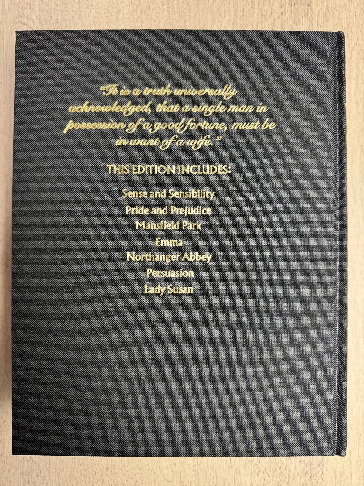 Black book cover with gold text on a wooden surface