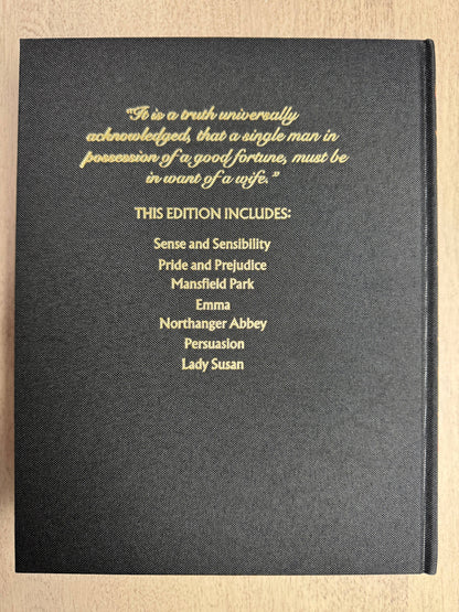 Black book cover with gold text on a wooden surface
