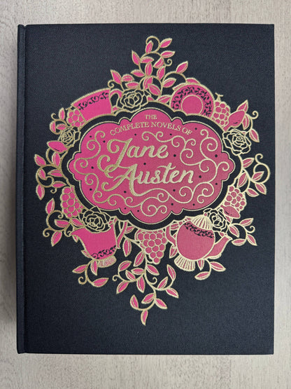 Jane Austen Complete Novels, Wordsworth Library Collection large hardcover book with black linen cloth binding, decorative gold foil details, colored page edges, and ribbon bookmark.