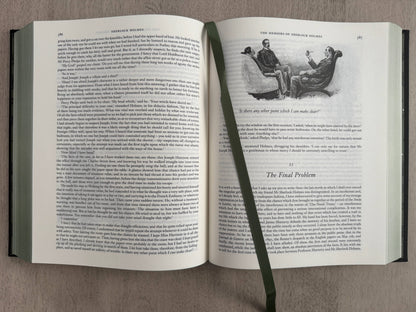 Open book with text and a small illustration on a gray background