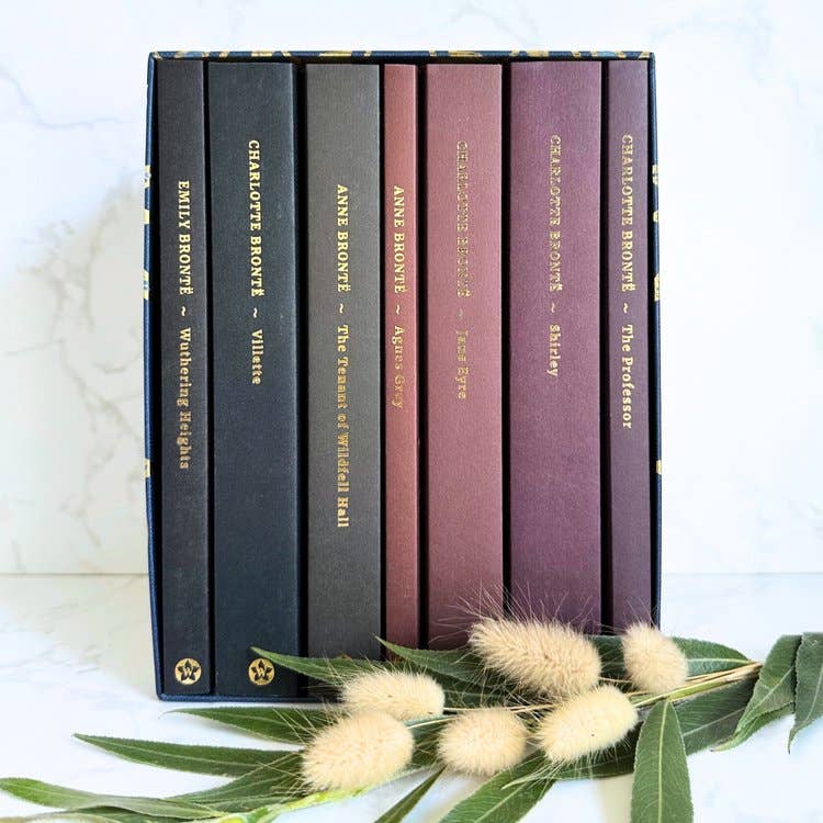 Set of books by Charlotte Bronte with decorative elements on a light background
