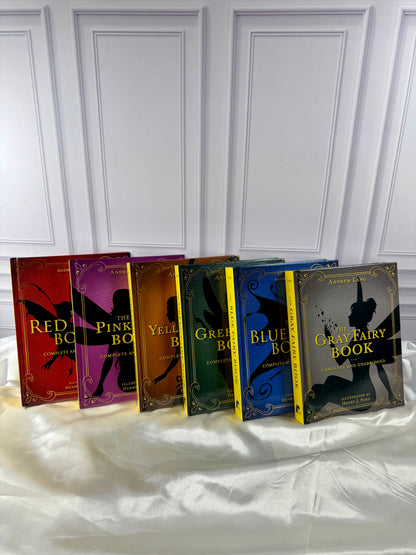 Six Andrew Lang Fairy Books displayed together: Red, Pink, Yellow, Green, Blue, and Gray, with colorful illustrated covers.