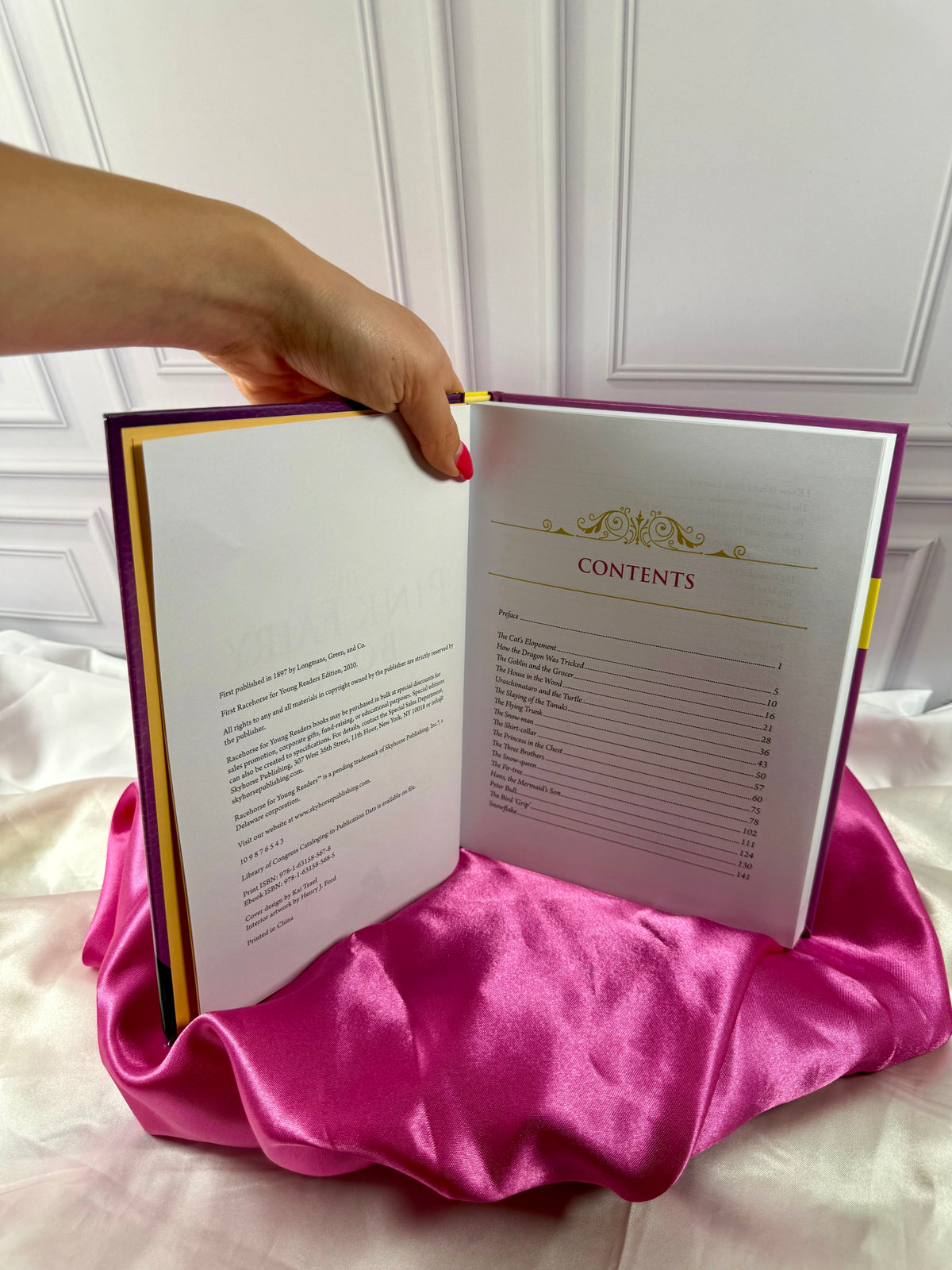 The Pink Fairy Book by Andrew Lang opened to its table of contents, featuring a selection of traditional fairy tales.