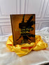 The Yellow Fairy Book by Andrew Lang, illustrated yellow hardcover with decorative gold lettering, displayed on satin at StoryGiftStudio.