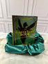 Green Fairy Book by Andrew Lang, illustrated hardcover with gold lettering and fairy silhouette, displayed on emerald satin at StoryGiftStudio.