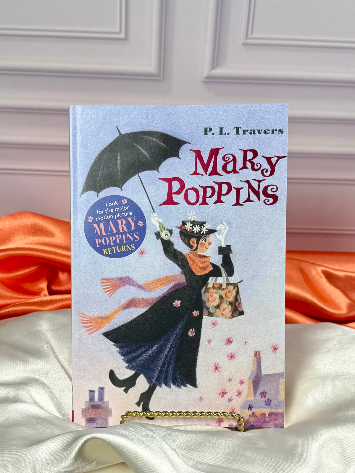 Individual Mary Poppins paperback book from the four-volume boxed set, featuring colorful illustrated cover artwork and classic characters.