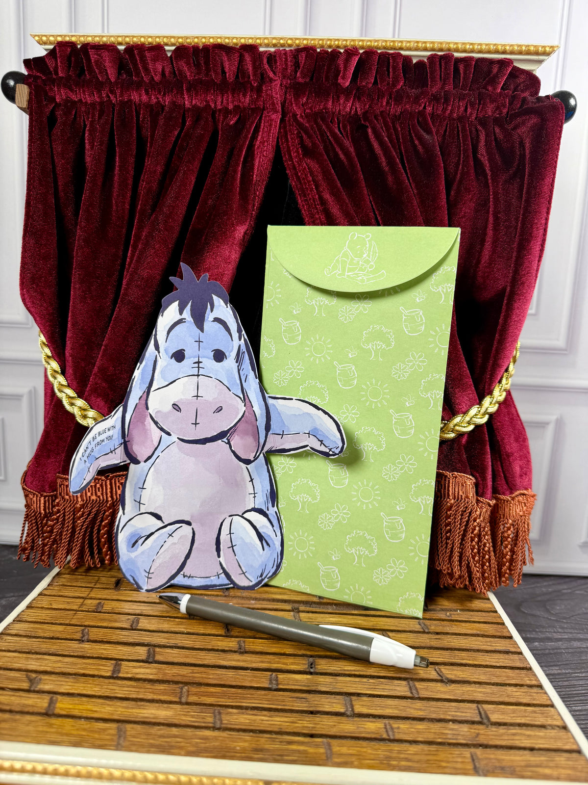 Disney Winnie the Pooh Hugs Eeyore character notecard shown folded with its arms enclosing a handwritten greeting.