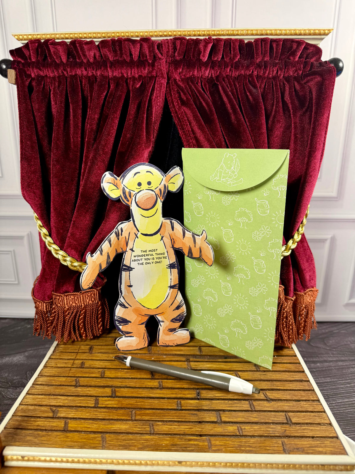 Disney Winnie the Pooh Hugs character Tigger notecard shown folded with its arms enclosing a handwritten greeting.