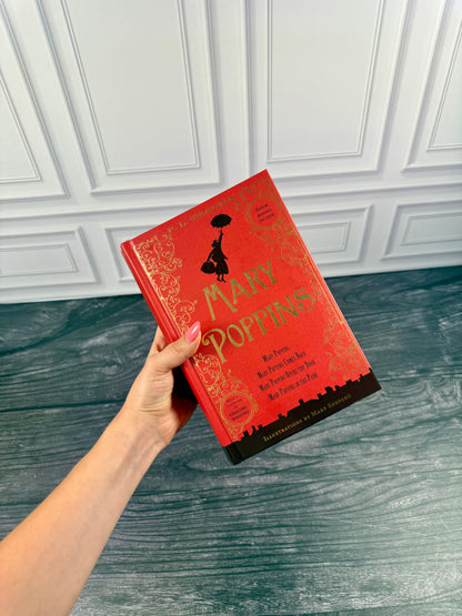 Mary Poppins Collection hardcover treasury held in one hand to show the size of the thick red book and its decorative cover.