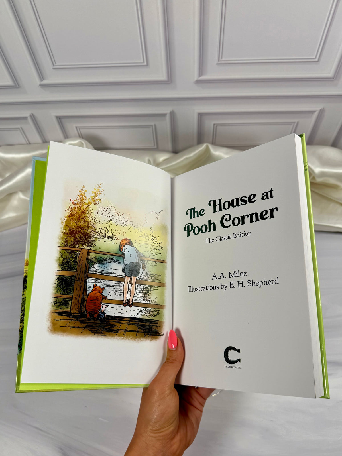 Open The House at Pooh Corner illustrated hardcover book showing title page and artwork in the Skyhorse Publishing edition.