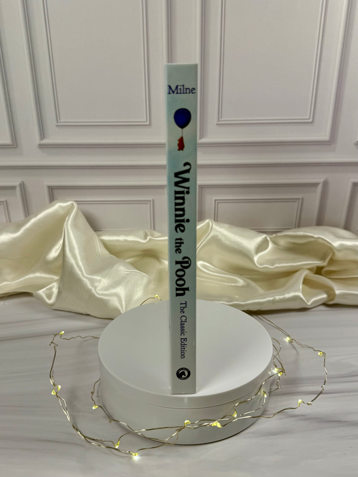 Winnie-the-Pooh illustrated hardcover displayed at an angle, showing the pale blue book cover and spine.