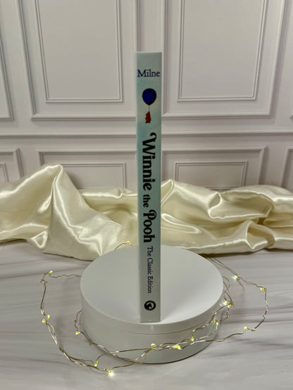Winnie-the-Pooh illustrated hardcover displayed at an angle, showing the pale blue book cover and spine.