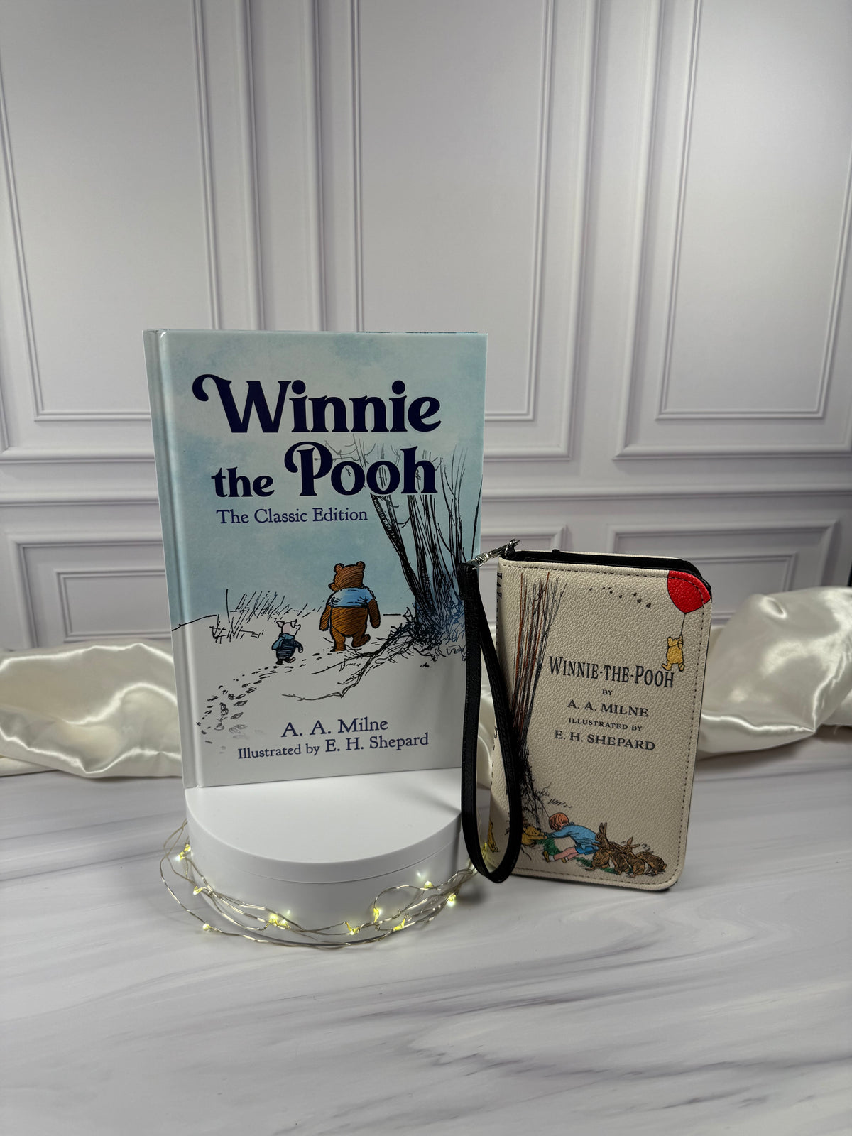 Winnie-the-Pooh by A. A. Milne hardcover photographed in a styled book display with its illustrated cover visible and matching book wallet sold separately 
