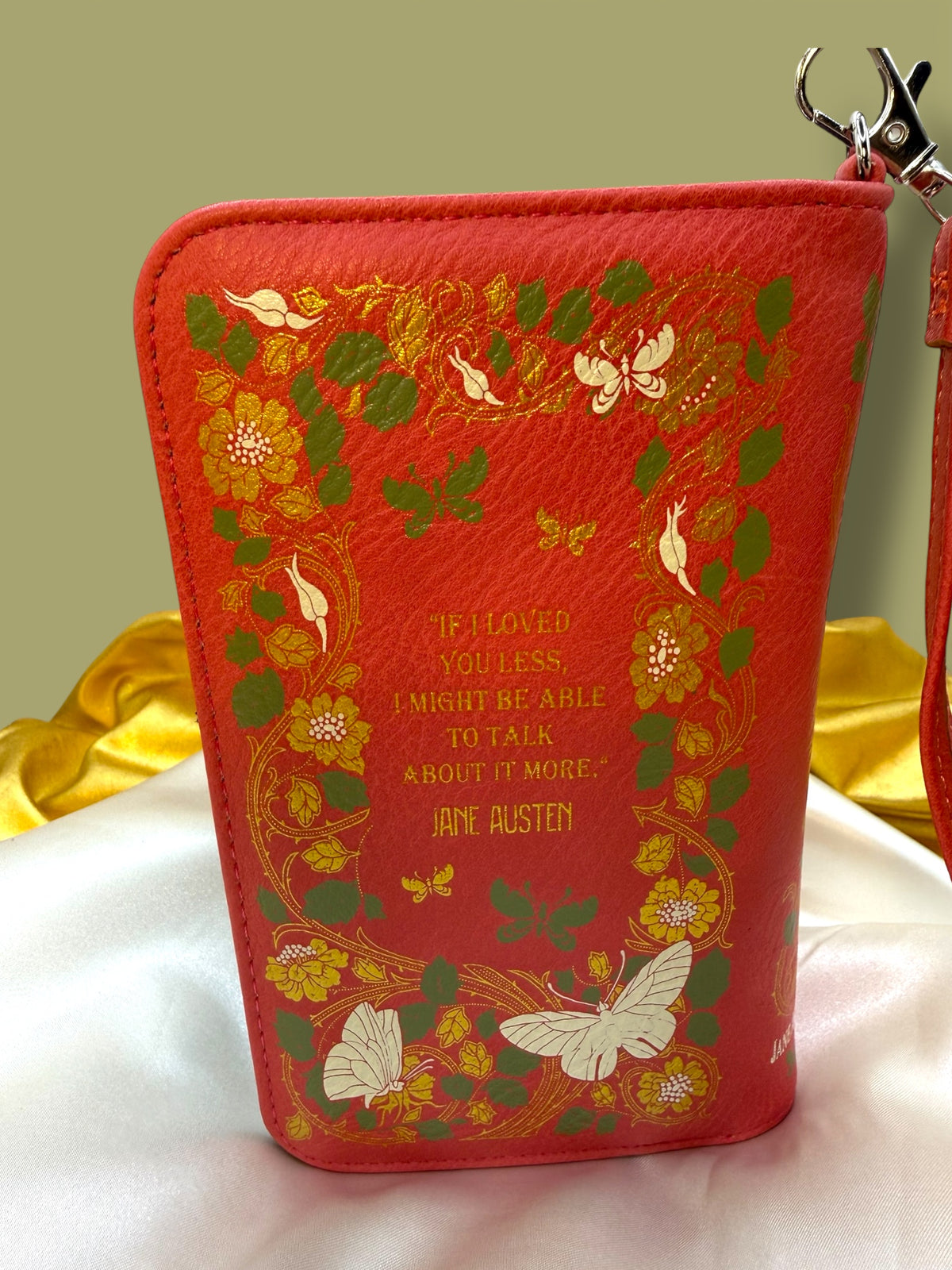 Back of the Jane Austen Emma Book Wallet featuring a bright coral background, colorful floral artwork, and decorative literary-inspired design.