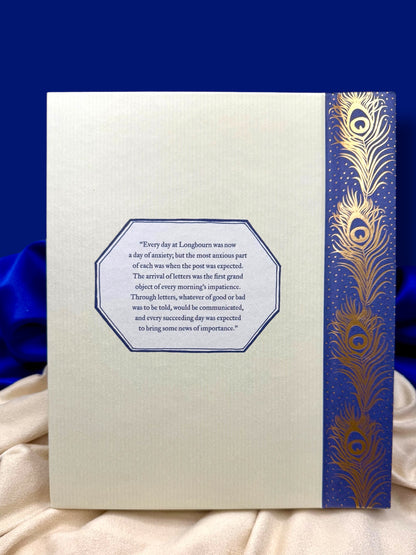 Back view of Pride and Prejudice deluxe edition, featuring its illustrated cream cover panel and ornate blue and gold floral border.