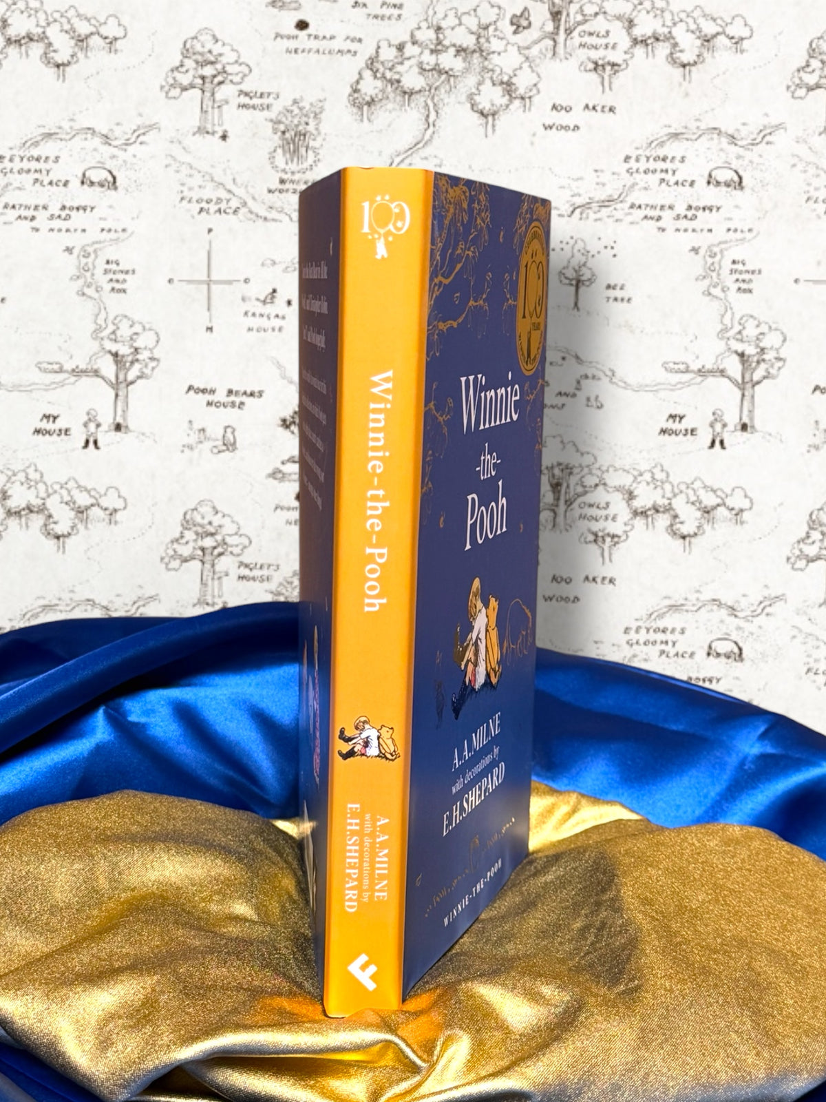 Winnie-the-Pooh illustrated hardcover showing yellow dust jacket spine and blue front cover with E. H. Shepard artwork