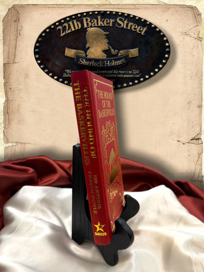 Spine view of The Hound of the Baskervilles red clothbound hardcover showing gold title lettering, Sir Arthur Conan Doyle&