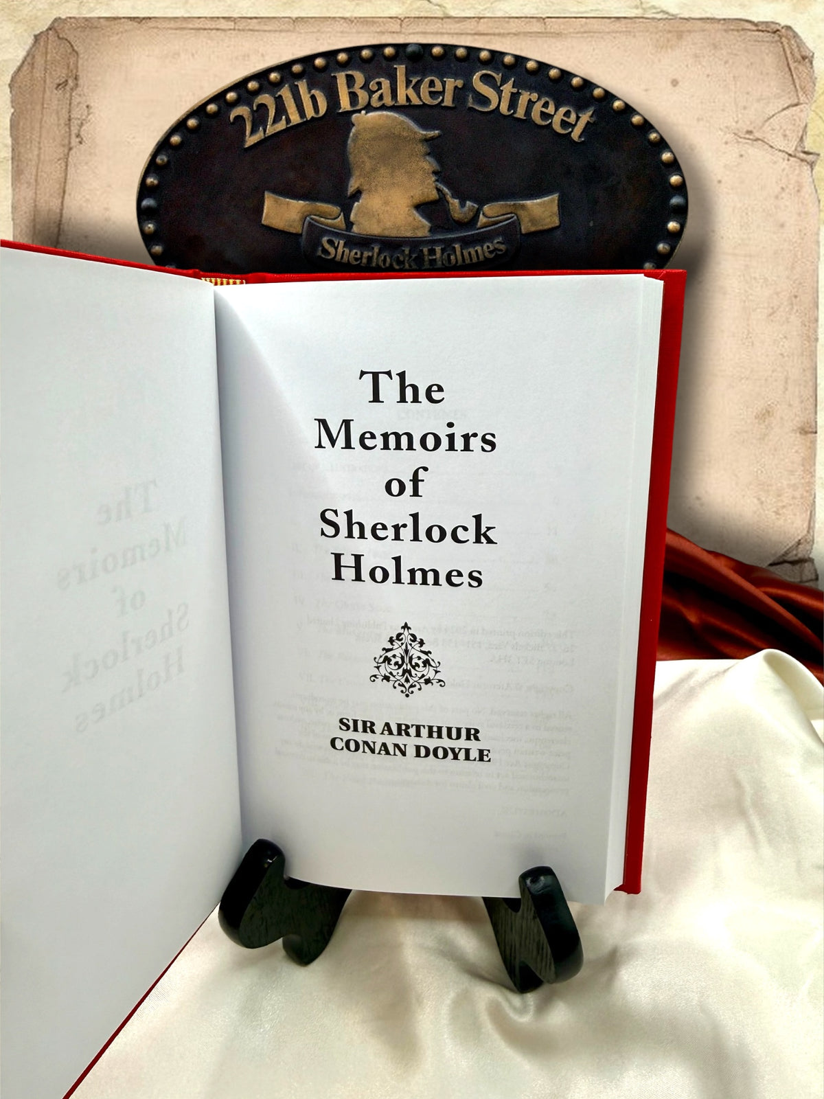 Open red clothbound edition of The Memoirs of Sherlock Holmes showing the interior title page with Sir Arthur Conan Doyle&
