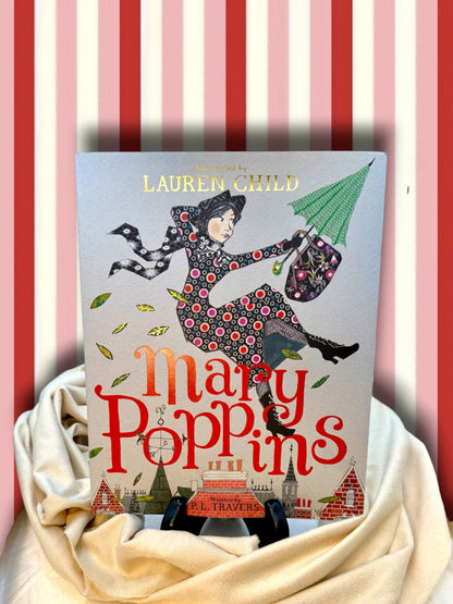 Mary Poppins Gift Edition by P. L. Travers, illustrated by Lauren Child, colorful hardcover displayed on ivory satin against a red-and-white striped backdrop.
