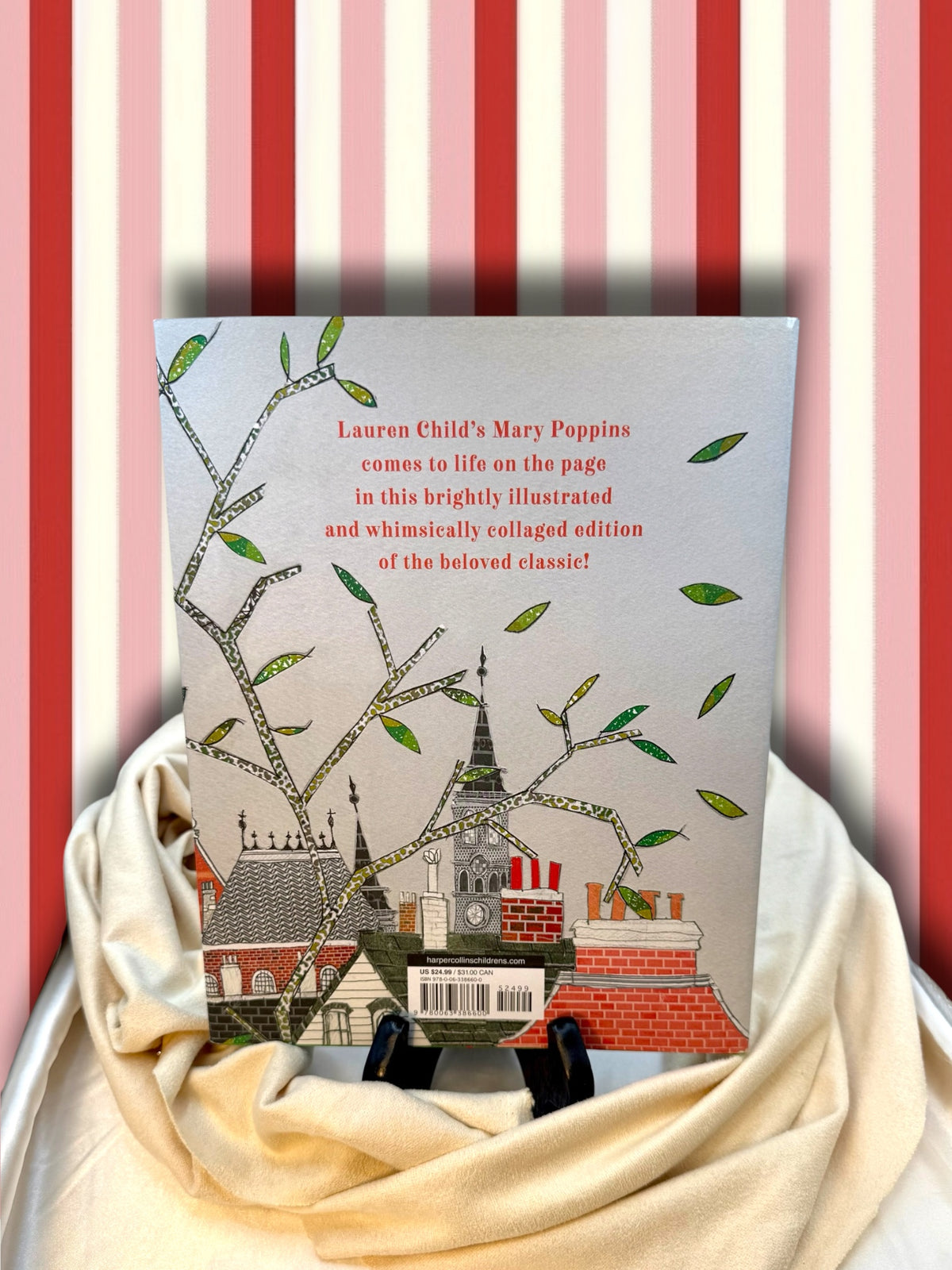 Rear view of the Mary Poppins Gift Edition hardcover by P. L. Travers, illustrated by Lauren Child, displayed against a striped backdrop.
