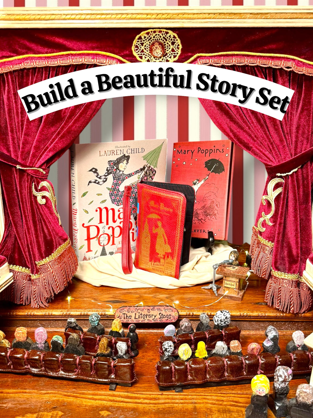 Mary Poppins literary gift collection displayed on a miniature theater stage with red velvet curtains, featuring two Mary Poppins books by P. L. Travers and a coordinating red book wallet. Books and wallet sold separately.