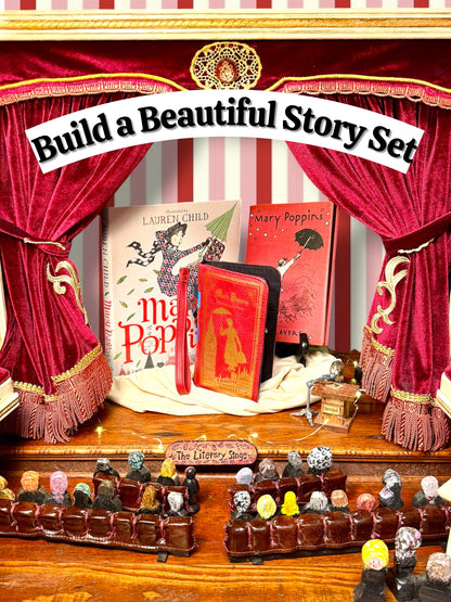 Mary Poppins literary gift collection displayed on a miniature theater stage with red velvet curtains, featuring two Mary Poppins books by P. L. Travers and a coordinating red book wallet. Books and wallet sold separately.