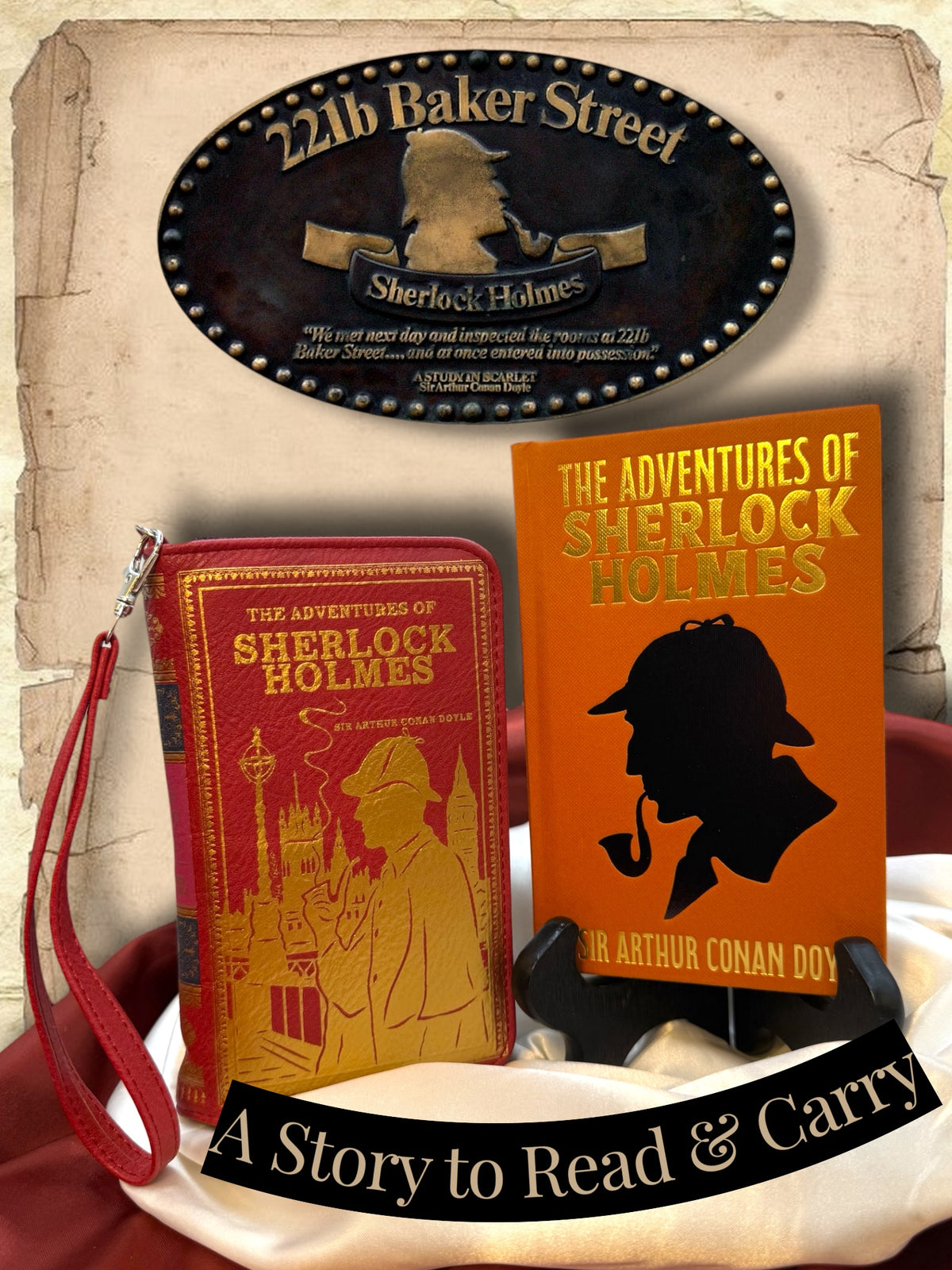 The Adventures of Sherlock Holmes orange hardcover displayed beside a coordinating red Sherlock Holmes book wallet, sold separately, with a 221B Baker Street plaque and satin backdrop.