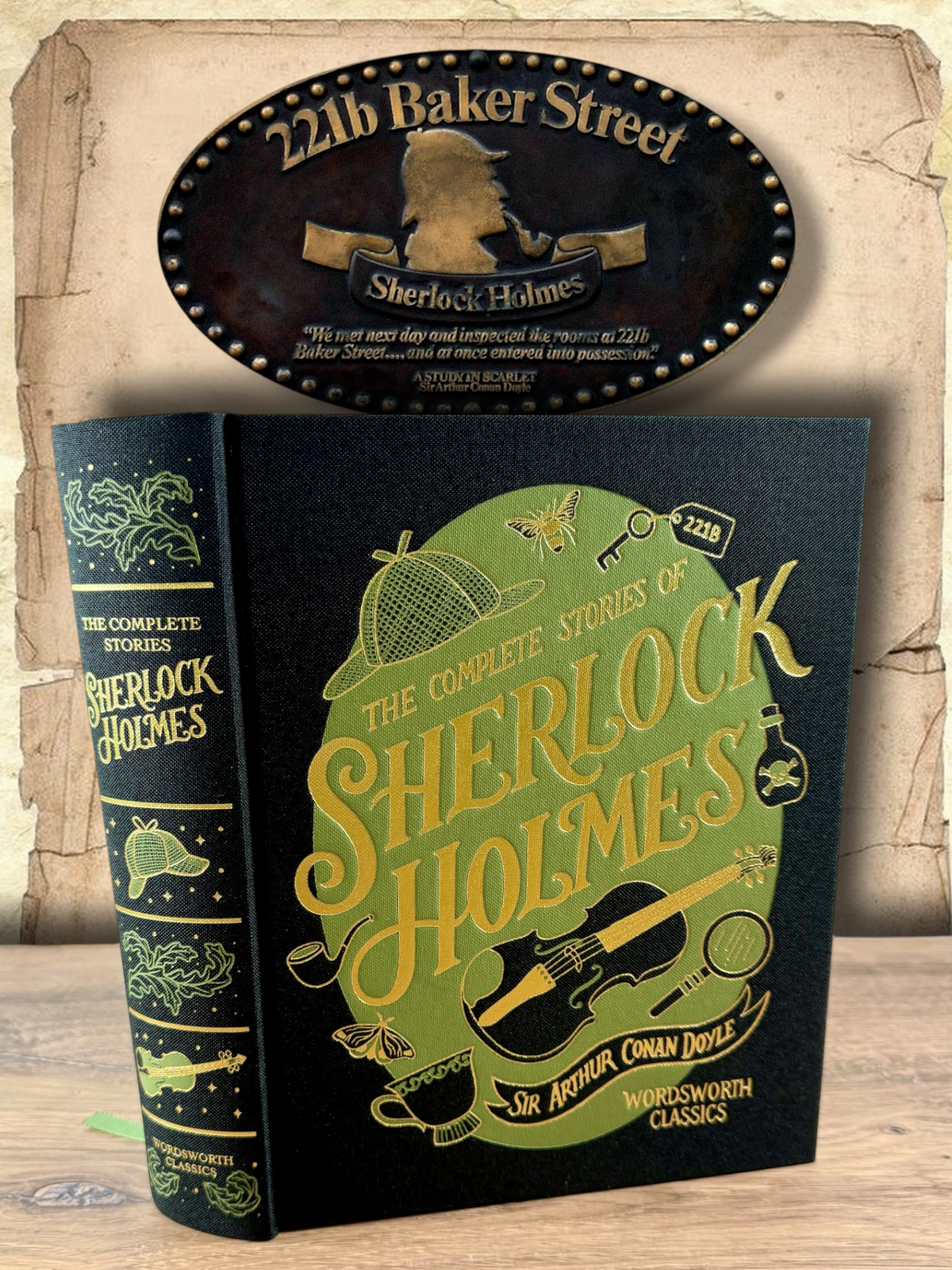 The Complete Stories of Sherlock Holmes by Arthur Conan Doyle, Wordsworth Classics clothbound hardcover with black fabric cover, decorative green and gold lettering, illustrated detective symbols and matching spine.