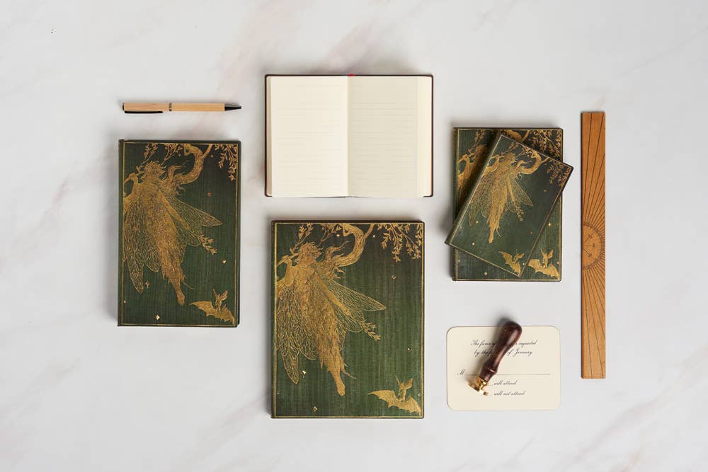 Set of green notebooks with fairy designs on a white surface