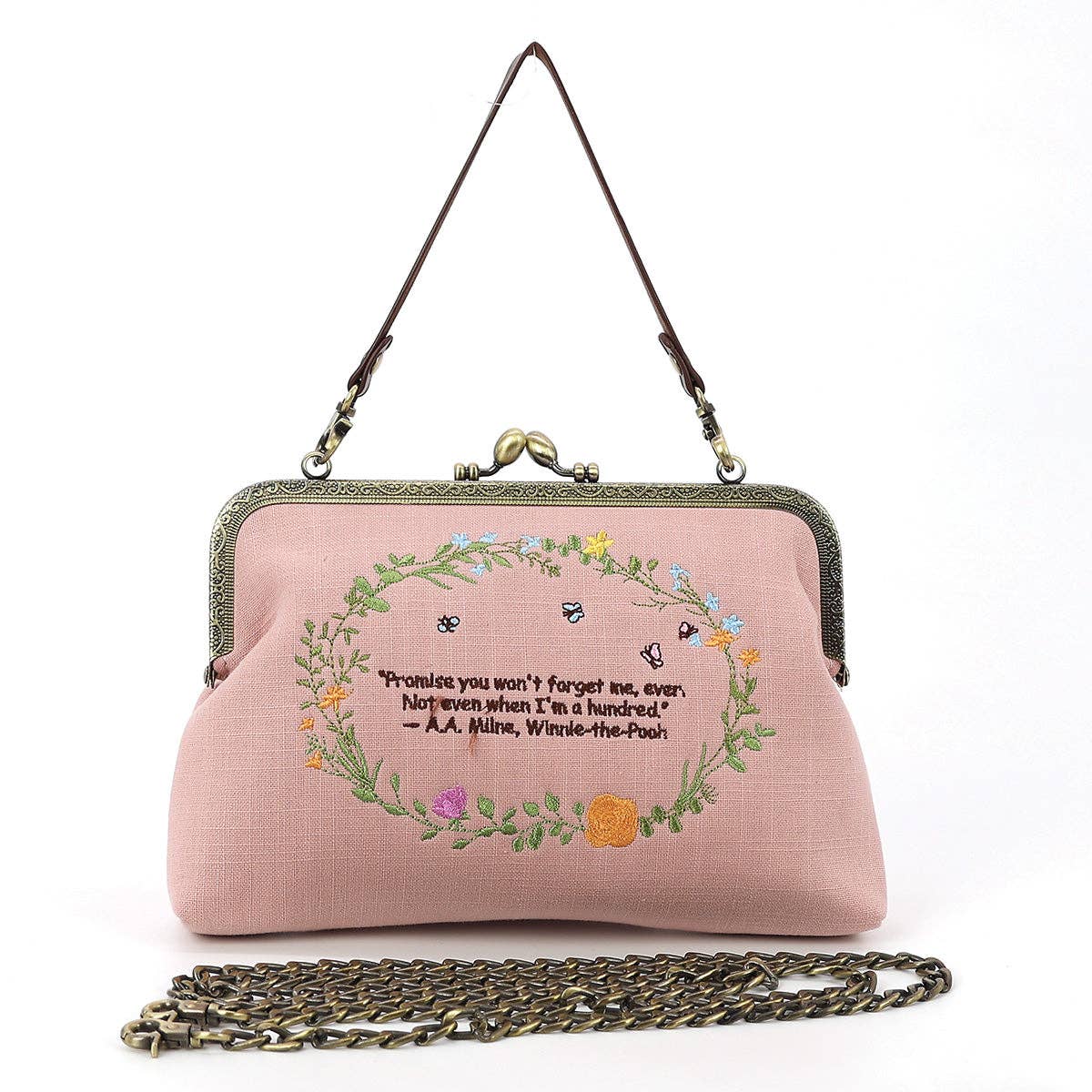 Back of pink Winnie-the-Pooh and Piglet kisslock handbag featuring an embroidered floral wreath and friendship quotation by A. A. Milne.