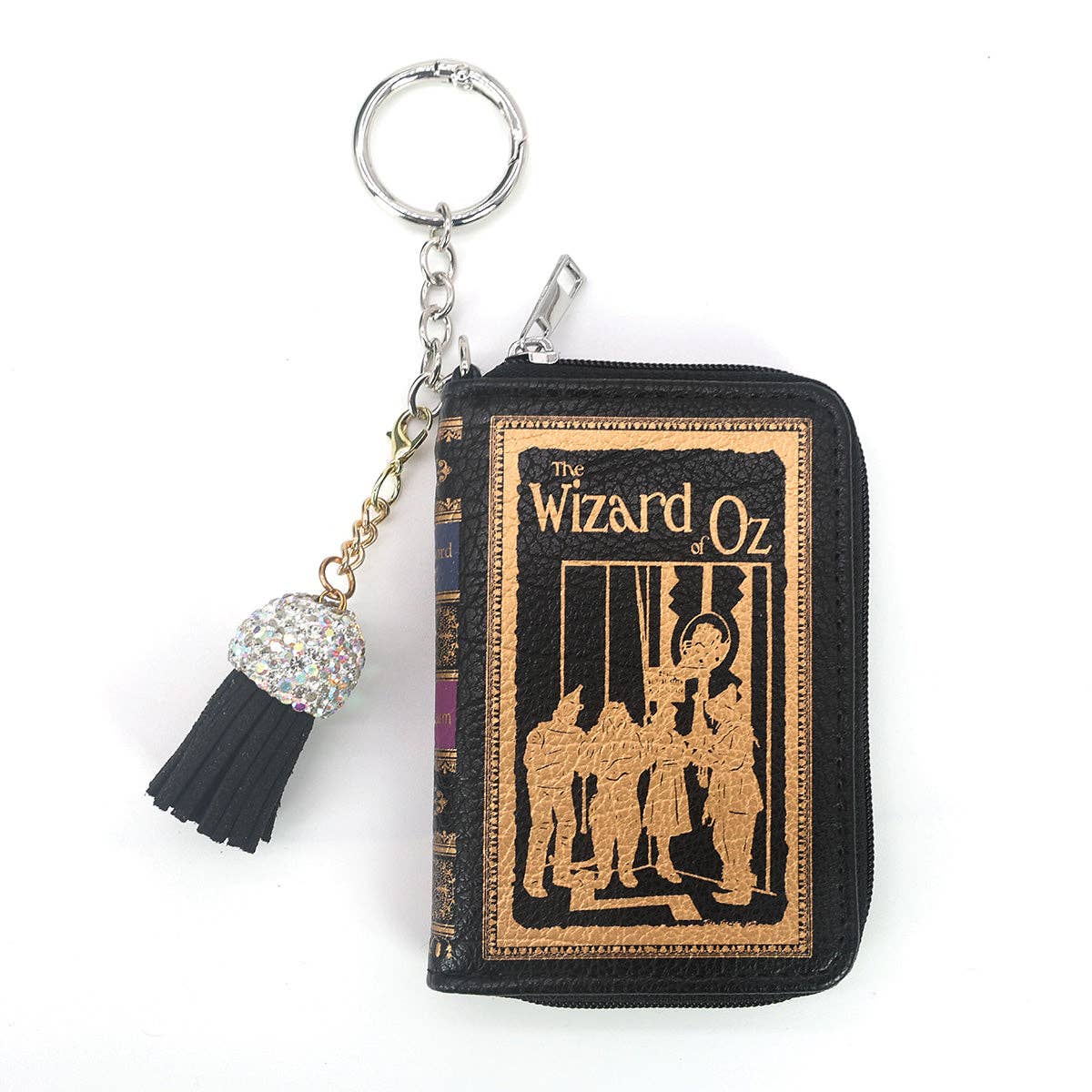 The Wizard of Oz miniature book-shaped vinyl coin purse and bag charm featuring colorful storybook cover artwork, a zippered compartment, and keychain attachment.