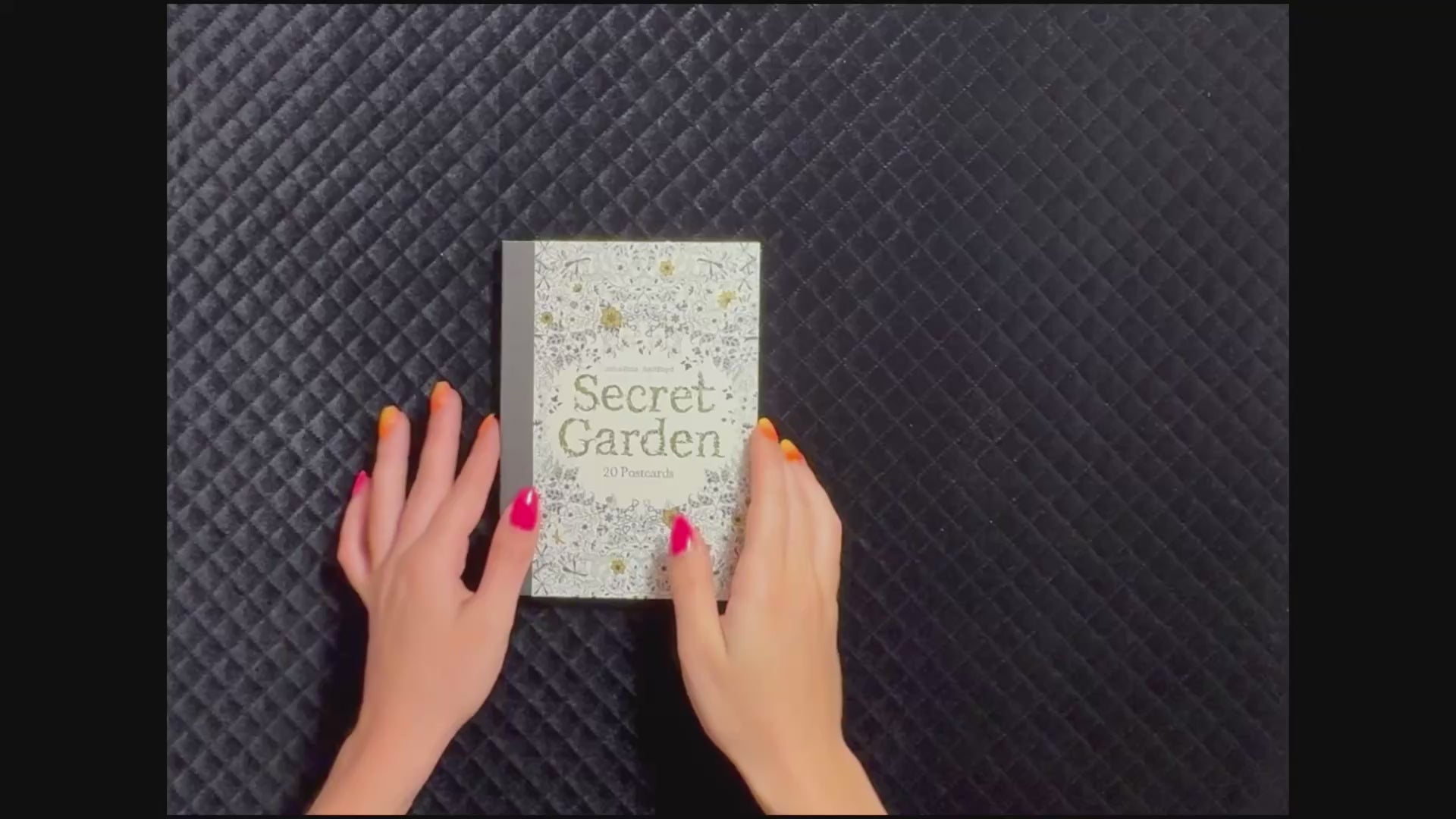 StoryGiftStudio™ product video showcasing Johanna Basford's Secret Garden collection of 20 detachable coloring postcards, including the illustrated cover, botanical designs, and postcard format for coloring and sharing.