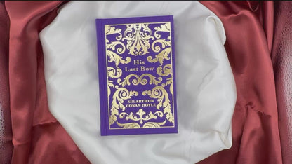 Video showcasing His Last Bow by Sir Arthur Conan Doyle, a purple clothbound Sherlock Holmes hardcover with ornate gold cover decoration.